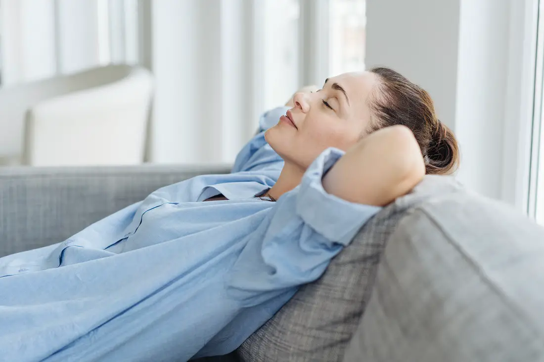 Exhausted young woman relaxing on a sofa